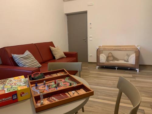 a living room with a couch and a tv at Affittacamere Il Borgo in Levanto