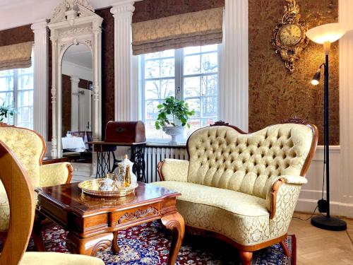 a living room with a chair and a table at Tokeryds Herrgård in Jönköping