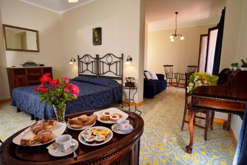 a room with a bed and a table with food on it at Gattopardo Park Hotel in Lipari
