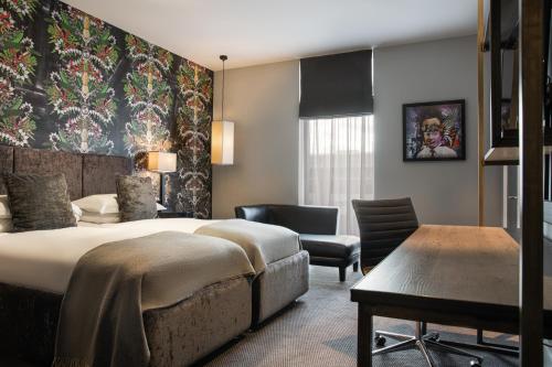 a hotel room with a bed and a chair at Malmaison Liverpool in Liverpool