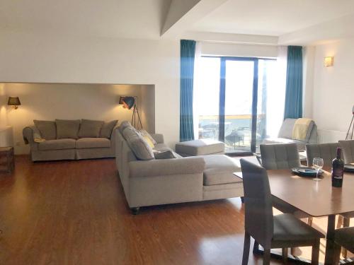 a living room with two couches and a table and a dining room at GVC 4-room 421 New Gudauri in Gudauri