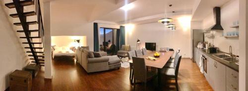 a kitchen and living room with a table and a couch at GVC 4-room 421 New Gudauri in Gudauri