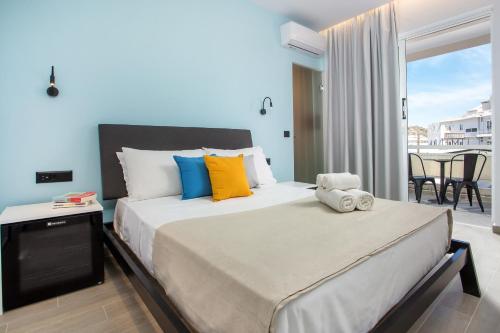 a bedroom with a large bed and a balcony at Faliraki Premium Hotel in Faliraki