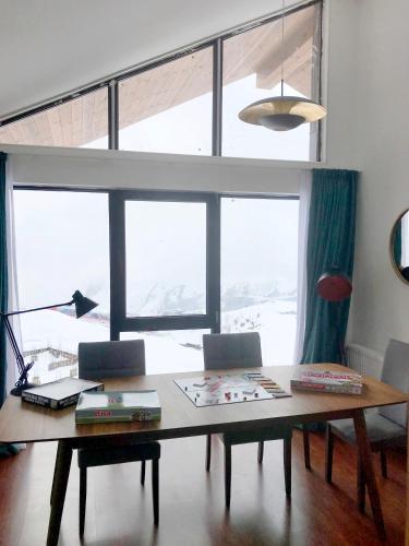 a room with a table and a large window at GVC 4-room 421 New Gudauri in Gudauri