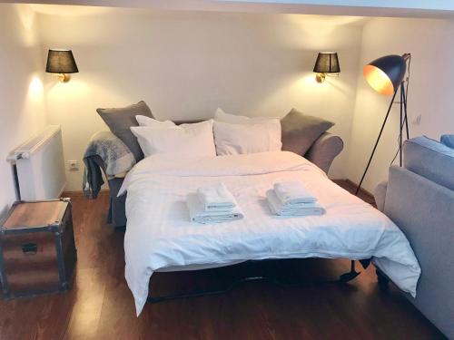 a bedroom with a large bed with two towels on it at GVC 4-room 421 New Gudauri in Gudauri