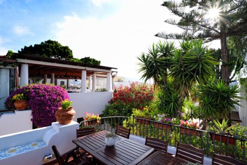 a balcony with a table and chairs and flowers at Gattopardo Park Hotel in Lipari