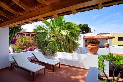 a patio with two chairs and a white fence at Gattopardo Park Hotel in Lipari