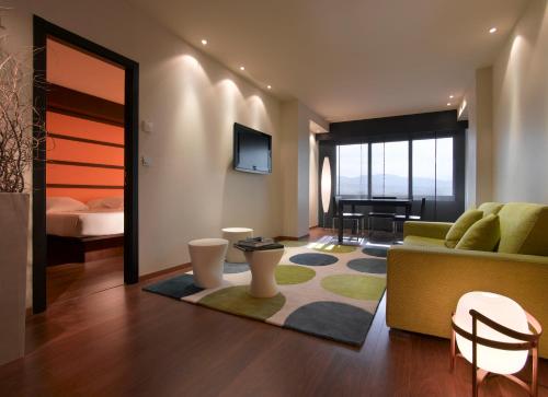 a living room with a couch and a bed at Hotel Abades Nevada Palace in Granada