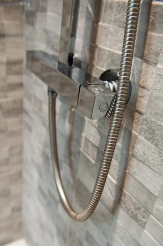 a hose hooked up to a wall with a shower at Osborne Hotel in Newcastle upon Tyne