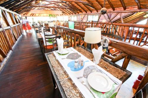 a dining room with a table in a barn at Roof of Africa Hotel in Windhoek