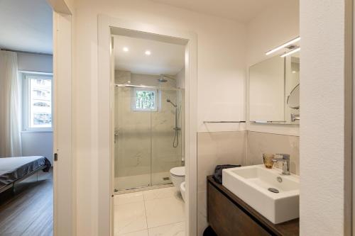 a bathroom with a shower and a sink and a toilet at The View in Baveno