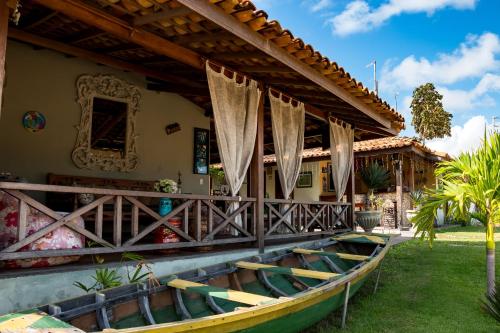 a house with a boat sitting outside of it at Pousada Jurará e Vila Jurará in Atins