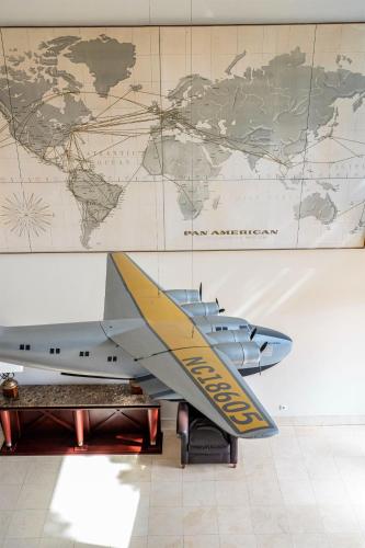 a model of an airplane on a wall with a map at Hotel do Canal in Horta