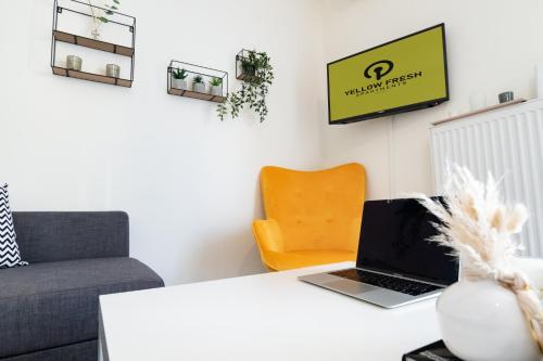 a living room with a laptop on a table at Yellow Fresh Apartment 2 in Alexandroupoli
