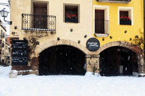 a building with two gates in the snow at Cal Tomaset in Prades