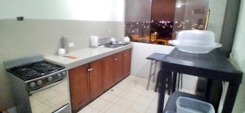 a kitchen with a counter with a cake on it at Blue Coast Lima private rooms Peru in Lima