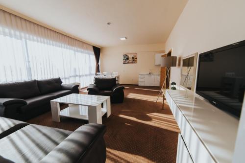a living room with a couch and a table at Hotel Brcko Gas Prijedor in Prijedor