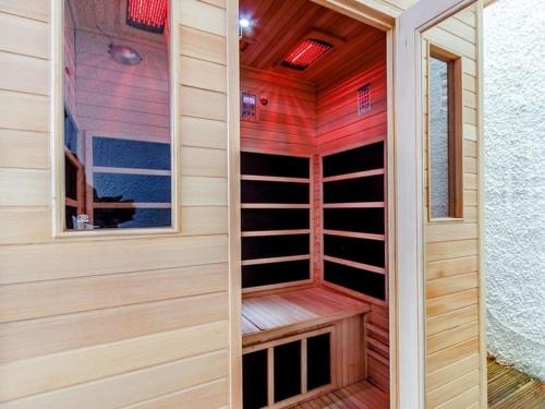 a wooden sauna with a window in a room at Golden Crown exclusive use spa venue in Tarbolton