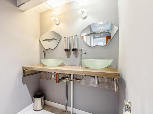 a bathroom with two sinks and a mirror at Golden Crown exclusive use spa venue in Tarbolton