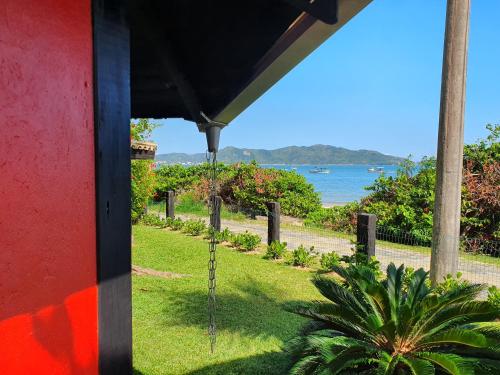 a view of the ocean from a house at Pousada dos Ingleses in Bombinhas