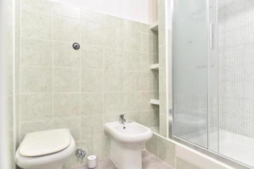 a bathroom with a toilet and a sink and a shower at GuestHouse o Affittacamere Magenta Baylon Suite in Rome