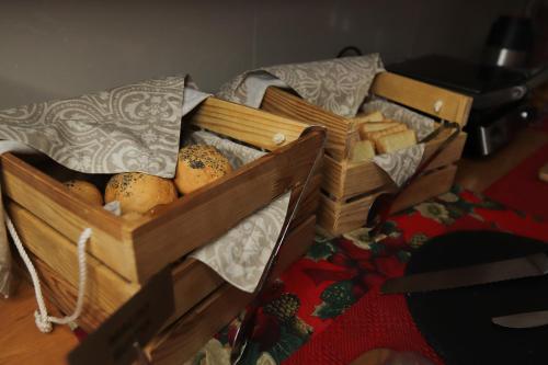 two wooden crates filled with bread and cheese at Hotel Plazma in Lviv