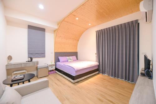 a small room with a bed and a couch at 鴻滿億民宿 in Magong
