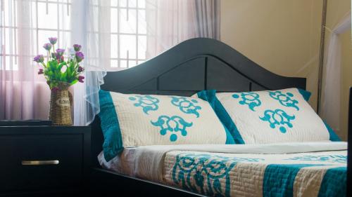 A bed or beds in a room at Bona Safari Villa Bunamwaya