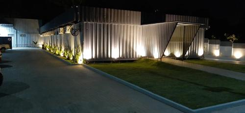 a building with lights on the side of it at night at Green It Motel & Hotel in Bragança Paulista