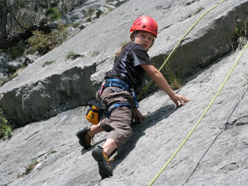 a young boy wearing a helmet on a rock wall at Haus Alpenblick in Ehrwald