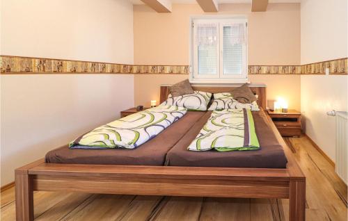 a large bed in a room with a window at Ferienhaus In Heiligenbrunn in Heiligenbrunn