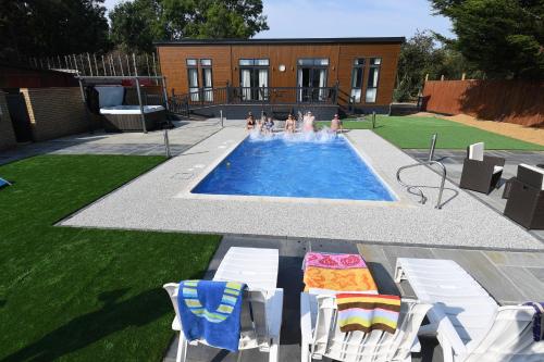 a group of children playing in a swimming pool at Spanhoe Lodge in Harringworth