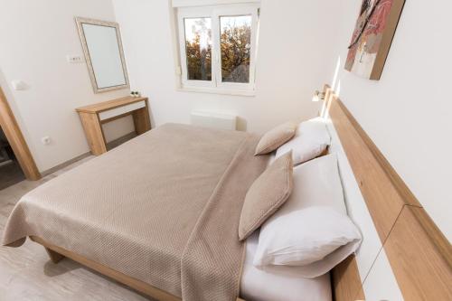 Ένα ή περισσότερα κρεβάτια σε δωμάτιο στο Apartmani Villa Paulo