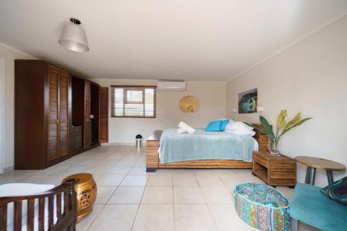 a bedroom with a bed and a table at Arubiana Inn Hotel in Palm-Eagle Beach