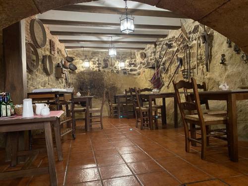 a restaurant with wooden tables and chairs in a room at Hotel rural Rinconada de las Arribes in Aldeadávila de la Ribera