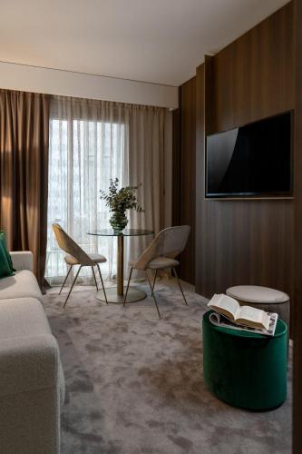 a living room with a couch and a table at We Me Suite Hotel in Riccione