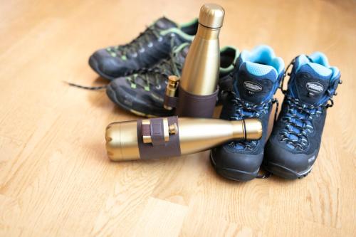 a bottle of champagne next to a group of boots at Stadthotel zur goldenen Krone in Weiz