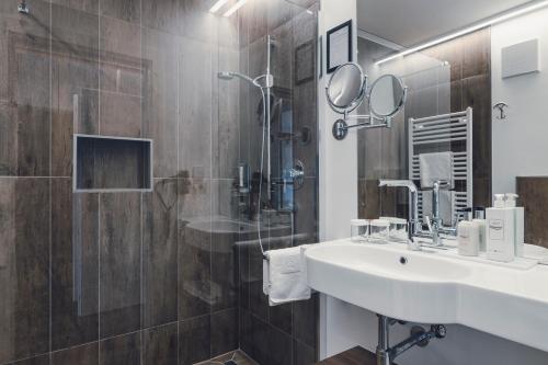 a bathroom with a sink and a shower at Golserhof in Tirolo