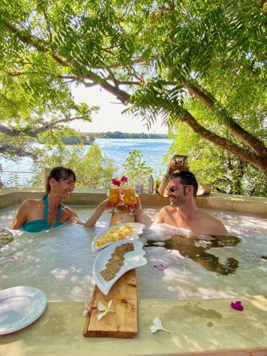 a man and a woman sitting in a bath tub at Rock and Sea Resort in Watamu
