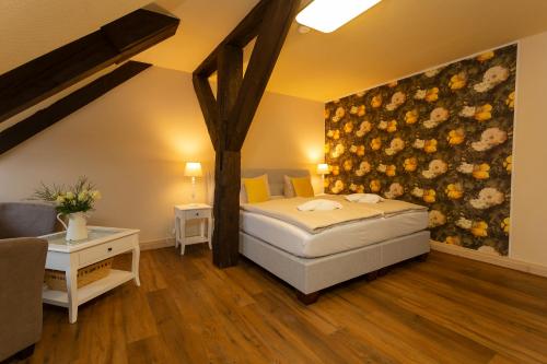a bedroom with a bed and a painting on the wall at Drostenhaus Feldberg in Feldberg