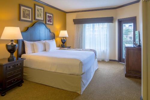 a hotel room with a large bed and a window at Bluegreen Vacations Grande Villas at World Golf Village in Saint Augustine