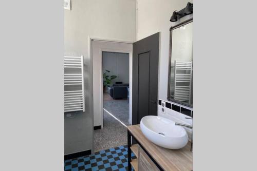 a bathroom with a large white sink and a mirror at Appartement indépendant dans maison de village in Saint-André-de-Sangonis