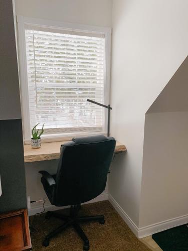 a desk with a chair in front of a window at The Inn at the Ninth Hole Bed & Breakfast in Salmon Arm