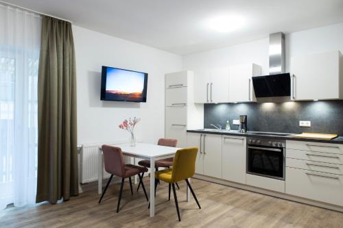 a kitchen and dining room with a table and chairs at Villa am Bahnhof in Fulda in Fulda