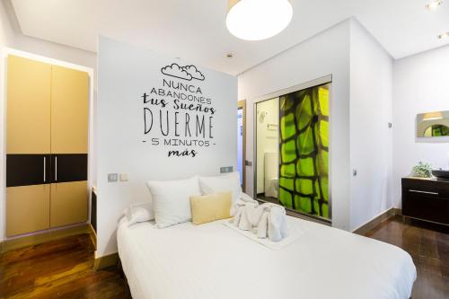 a hotel room with white walls and a white bed at Madrid House Rooms in Madrid