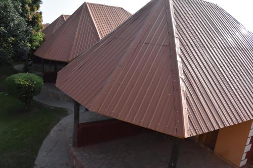 a roof of a building with rusty metal roofs at Secrets Guest House in Entebbe