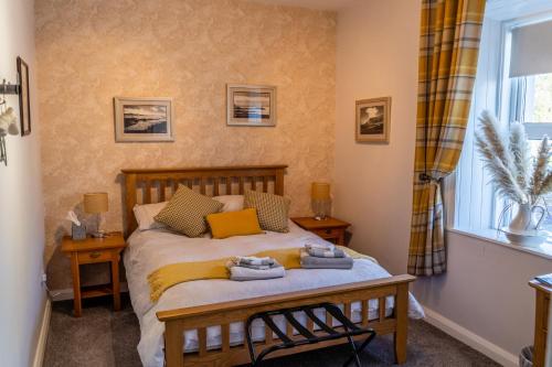 a bedroom with a bed and a window at The Mulberrys B&B in Downpatrick