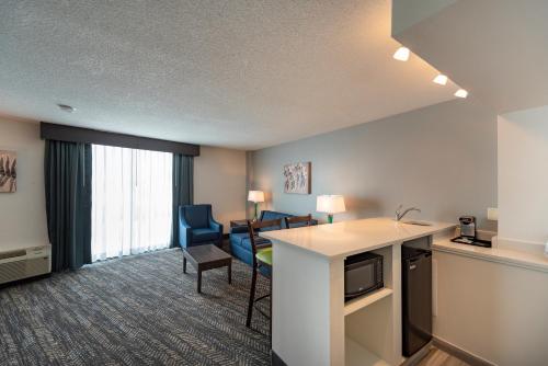 a hotel room with a kitchen and a living room at Best Western Plus Wausau Tower Inn in Wausau