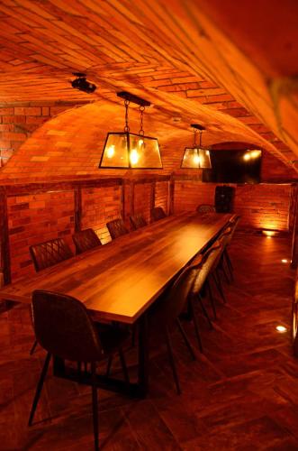 a long table in a room with chairs and lights at Sieburczynianka in Wizna