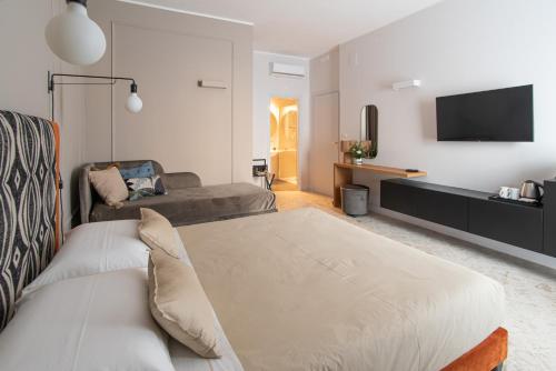 a living room with a bed and a couch at Casa Almika Sparano in Bari